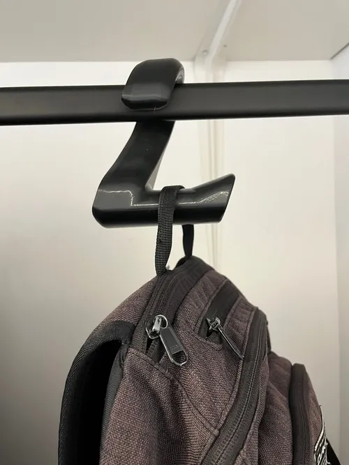 Backpack bag hanger mounted on a desk
