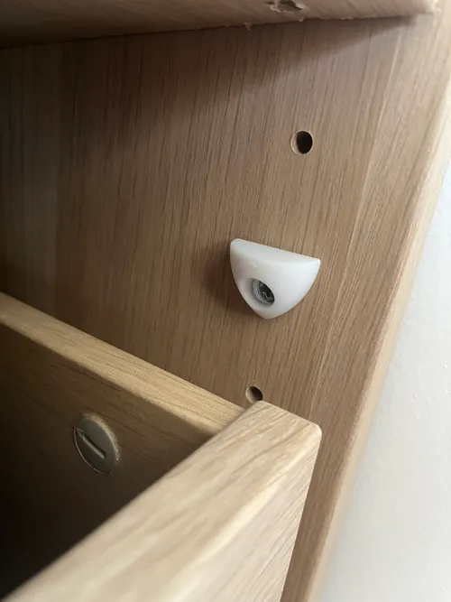 3D printed shelf brackets holding a wooden shelf