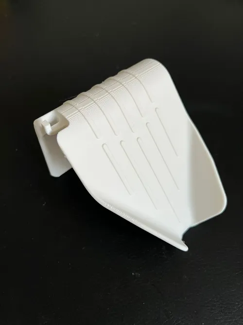 Self-draining soap dish and sponge holder next to a sink