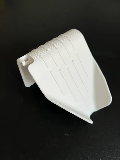 Self-draining soap dish and sponge holder next to a sink