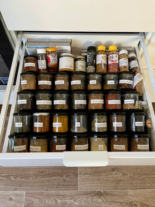 Modular drawer spice rack filled with jars
